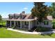 Charming home with a covered porch, perfect for relaxing and enjoying the view, surrounded by greenery at 4611 Executive Meadows Dr, Plant City, FL 33567