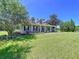 Inviting home with a wide porch, dark shutters, and landscaped garden, creating a welcoming curb appeal at 4611 Executive Meadows Dr, Plant City, FL 33567