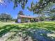 Expansive lawn, covered porch, and meticulous landscaping accent this home's exterior appeal at 4611 Executive Meadows Dr, Plant City, FL 33567