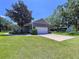 Charming single-story home boasts a two-car garage, mature trees and meticulously maintained landscaping at 4611 Executive Meadows Dr, Plant City, FL 33567