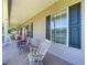 Charming front porch with rocking chairs and large window overlooking the front yard at 4611 Executive Meadows Dr, Plant City, FL 33567
