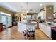 Open kitchen featuring hardwood floors, stainless steel appliances, and a large island at 4611 Executive Meadows Dr, Plant City, FL 33567