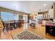 Open kitchen and dining area featuring hardwood floors, center island, and stainless steel appliances at 4611 Executive Meadows Dr, Plant City, FL 33567