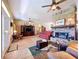 Cozy living room featuring a brick fireplace, hardwood floors, and ample natural light at 4611 Executive Meadows Dr, Plant City, FL 33567