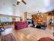 Spacious living room with hardwood floors, brick fireplace, and decorative wood accent wall at 4611 Executive Meadows Dr, Plant City, FL 33567