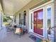 Inviting front porch featuring rocking chairs, a red door, and country-style decor, offering a relaxed atmosphere at 4611 Executive Meadows Dr, Plant City, FL 33567