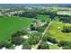 Aerial view highlighting property amidst green expanses with neighboring houses, a tranquil setting at 4616 Edwards Rd, Plant City, FL 33567