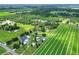 This aerial shot shows a serene property with green fields and neighboring homes at 4616 Edwards Rd, Plant City, FL 33567