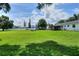 Expansive back yard featuring lush lawn, mature trees and inviting patio area perfect for outdoor relaxation at 4616 Edwards Rd, Plant City, FL 33567