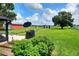 Backyard with a lush garden, mature trees, and outdoor grill creating a serene and inviting space at 4616 Edwards Rd, Plant City, FL 33567