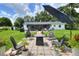 Backyard patio with outdoor seating, a fire pit, and a well-manicured lawn at 4616 Edwards Rd, Plant City, FL 33567