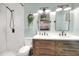 Modern bathroom features a double sink vanity, white subway tile shower and unique mirror at 4616 Edwards Rd, Plant City, FL 33567