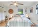 Comfortable bedroom features a ceiling fan, stylish decor, and large windows for natural light at 4616 Edwards Rd, Plant City, FL 33567