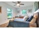 Cozy bedroom featuring plush carpeting, sunny windows, and neutral paint at 4616 Edwards Rd, Plant City, FL 33567