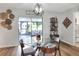 Bright dining area featuring a modern chandelier, table setting and view of the outdoor patio at 4616 Edwards Rd, Plant City, FL 33567