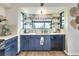 Nicely updated kitchen with blue cabinets, white countertops, stylish fixtures and a window over the sink at 4616 Edwards Rd, Plant City, FL 33567