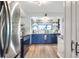 Bright kitchen with blue cabinets, stainless steel appliances, plenty of counterspace and modern decor at 4616 Edwards Rd, Plant City, FL 33567
