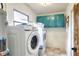 Well-equipped laundry room featuring modern washer, dryer, and ample counter space at 4616 Edwards Rd, Plant City, FL 33567