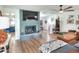 Bright living room featuring a brick fireplace, hardwood floors, and an open concept design at 4616 Edwards Rd, Plant City, FL 33567
