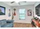 Comfortable living room featuring a sofa, wall art, and natural light from the windows at 4616 Edwards Rd, Plant City, FL 33567