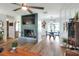 Open living room features a fireplace, ceiling fan, and hardwood floors that lead to the dining room at 4616 Edwards Rd, Plant City, FL 33567