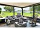 Comfortable sunroom with plush sectional sofa, rocking chair, and serene backyard views at 4616 Edwards Rd, Plant City, FL 33567
