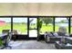 Relaxing sunroom with modern seating, potted plants, and large windows overlooking the property at 4616 Edwards Rd, Plant City, FL 33567