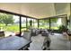Bright sunroom with modern furniture, plants, and views of the spacious backyard at 4616 Edwards Rd, Plant City, FL 33567