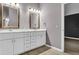 Elegant bathroom featuring double sinks, marble countertops, and wood floors at 8050 Eacon Ct, Hudson, FL 34667
