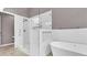 Modern bathroom featuring a standalone tub, a walk-in shower and grey accent walls at 8050 Eacon Ct, Hudson, FL 34667