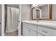Updated bathroom featuring a white vanity, framed mirror, and tub with shower at 8050 Eacon Ct, Hudson, FL 34667