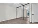 Bright bedroom with a mirrored closet door and new flooring at 8050 Eacon Ct, Hudson, FL 34667