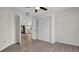 Spacious bedroom with a ceiling fan and closet; connected to other rooms at 8050 Eacon Ct, Hudson, FL 34667