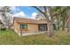 Backyard view of home with screened in lanai at 8050 Eacon Ct, Hudson, FL 34667