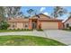 Charming single-Gathering home featuring a well-maintained lawn and attached two car garage at 8050 Eacon Ct, Hudson, FL 34667
