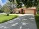 Charming single-Gathering home with a well-manicured lawn and long driveway leading to attached garage at 8050 Eacon Ct, Hudson, FL 34667