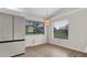 Eat in kitchen with stainless steel refrigerator and view to the front yard at 8050 Eacon Ct, Hudson, FL 34667