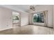 Bright living area with wood floors, modern light fixture, and large window at 8050 Eacon Ct, Hudson, FL 34667