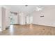 Open-concept living room with neutral walls, wood-look floors, and plenty of natural light at 8050 Eacon Ct, Hudson, FL 34667