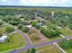 Wide aerial shot showcases the home's location on a spacious lot with mature trees in a serene neighborhood at 12410 Myrtlewood Dr, Riverview, FL 33579