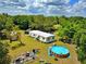 View of a backyard featuring an above ground pool, home and tree coverage providing shade and privacy at 12410 Myrtlewood Dr, Riverview, FL 33579