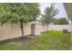 Spacious fenced backyard with lush green grass and trees at 32668 Abby Lax Ln, Wesley Chapel, FL 33543