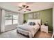 Cozy bedroom featuring a ceiling fan and natural light from a large window at 32668 Abby Lax Ln, Wesley Chapel, FL 33543