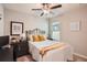 Bedroom featuring an iron bed frame, ceiling fan, and a corner desk area at 32668 Abby Lax Ln, Wesley Chapel, FL 33543