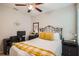 Bedroom with iron bed frame, yellow accents, and an adjoining desk area at 32668 Abby Lax Ln, Wesley Chapel, FL 33543
