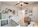 Bedroom with crib, changing table, and bookshelves perfect for a young  at 32668 Abby Lax Ln, Wesley Chapel, FL 33543