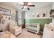 Charming Bedroom with white crib, rocking chair, and whimsical animal art at 32668 Abby Lax Ln, Wesley Chapel, FL 33543