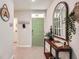 Bright entryway with stylish console table and decorative mirror at 32668 Abby Lax Ln, Wesley Chapel, FL 33543