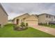 Single-story home with a well-kept lawn and garden at 32668 Abby Lax Ln, Wesley Chapel, FL 33543