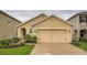 Charming single-story home featuring a two-car garage and well-manicured landscaping at 32668 Abby Lax Ln, Wesley Chapel, FL 33543